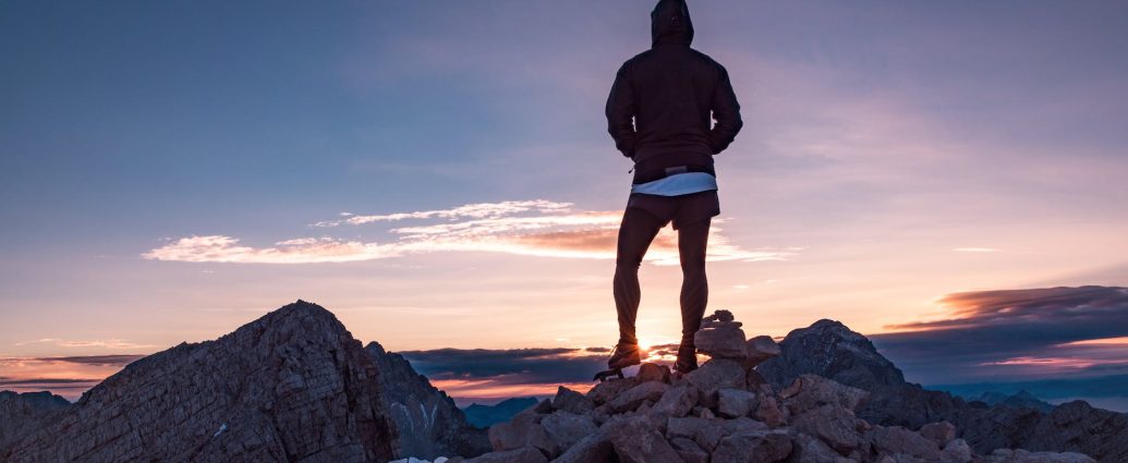 person standing on rock formation during golden hour