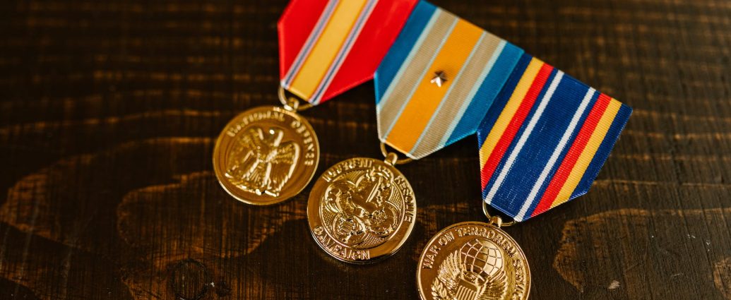 close up photo of medals on wooden surface