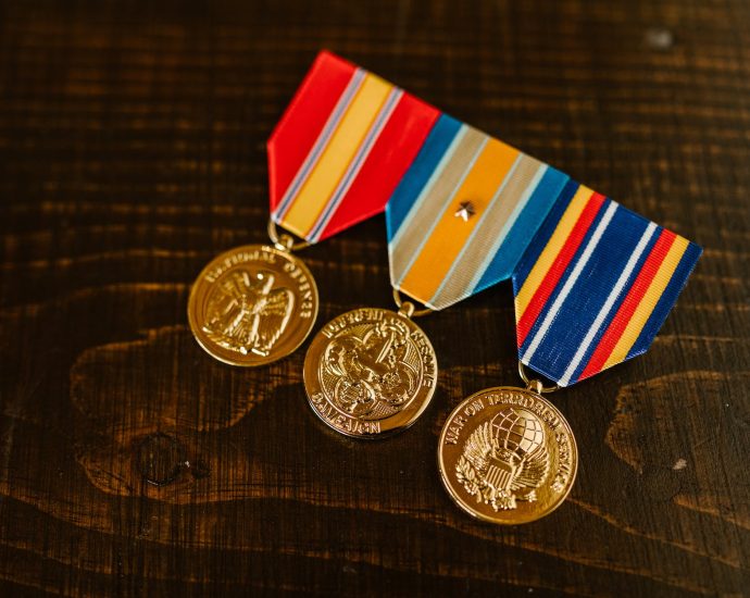 close up photo of medals on wooden surface